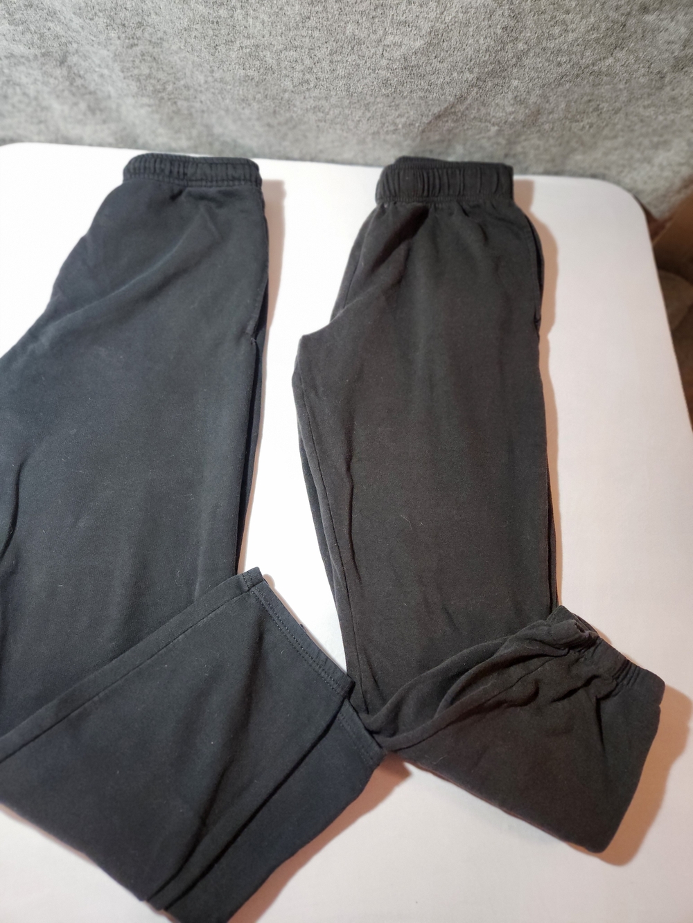 (2) Men's Black Sweatpants Size Medium. Fading and piling due to wear